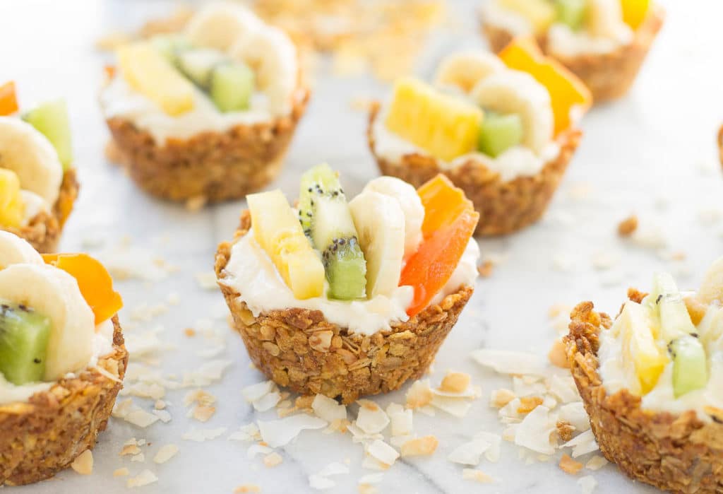 Head to the islands with these Tropical Granola Cups. These cups are made with Honey Bunches of Oats® cereal, bananas, oatmeal and coconut. Then filled with yogurt and delicious tropical fruits. You'll feel like you're on an island oasis every morning! | Strawberry Blondie Kitchen