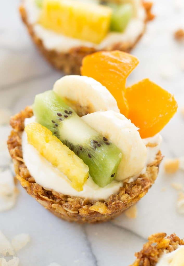 Head to the islands with these Tropical Granola Cups. These cups are made with Honey Bunches of Oats® cereal, bananas, oatmeal and coconut. Then filled with yogurt and delicious tropical fruits. You'll feel like you're on an island oasis every morning! | Strawberry Blondie Kitchen