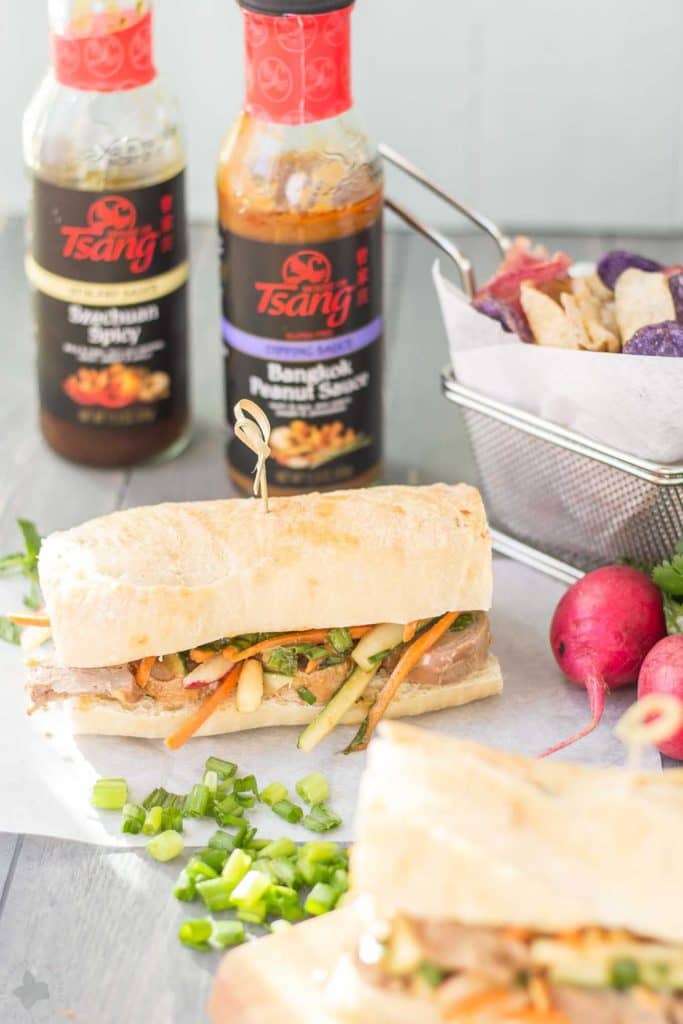 These Banh Mi Sandwiches are packed with bold Asian flavors. Pork is marinated in House of Tsang Szechuan SpicyTM Sauce and their Bangkok Peanut SauceTM dresses the vegetable coleslaw, which is piled high on top the pork. A few peanuts are added for crunch and you’ve got yourself the perfect Banh Mi Sandwich. | Strawberry Blondie Kitchen