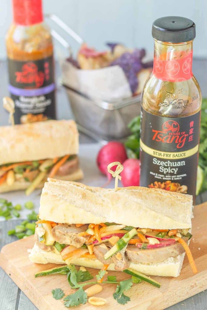 These Banh Mi Sandwiches are packed with bold Asian flavors. Pork is marinated in House of Tsang Szechuan SpicyTM Sauce and their Bangkok Peanut SauceTM dresses the vegetable coleslaw, which is piled high on top the pork. A few peanuts are added for crunch and you’ve got yourself the perfect Banh Mi Sandwich. | Strawberry Blondie Kitchen