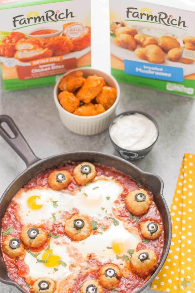 Eggs are baked in a tomato sauce and then breaded mushrooms with sliced black olives, made to looks like eyes, are nestled alongside to create this Halloween Eyeball Skillet. A festive meal sure to please the entire family! | Strawberry Blondie Kitchen