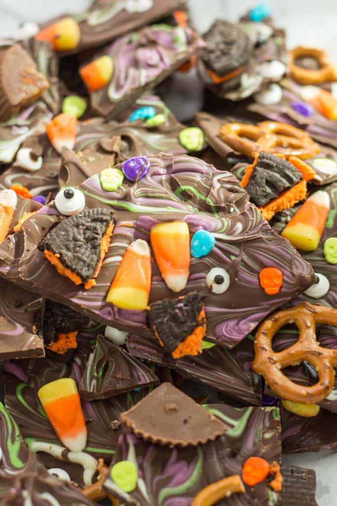 Halloween Candy Bark is a fun and spooky way to bring the deliciousness of Halloween candy into a colorful, no bake bark your whole family can customize. Use Hefty® Slider Bags and cleanup is a breeze! | Strawberry Blondie Kitchen