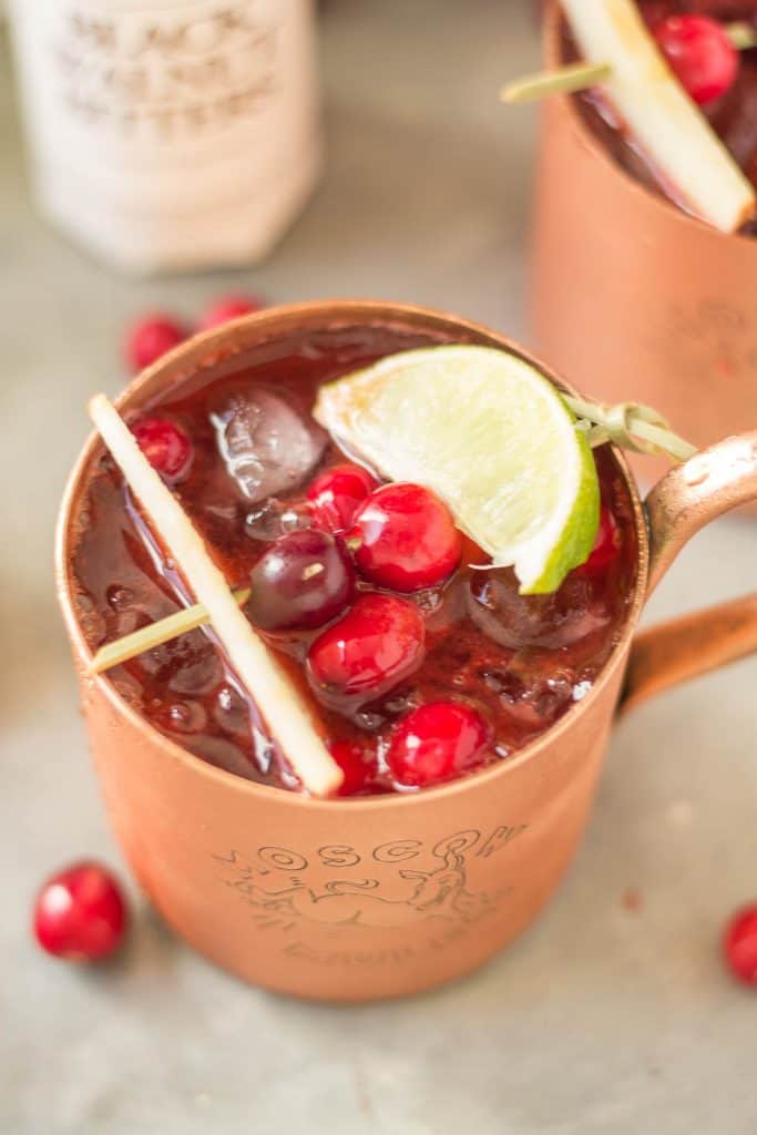 Serve this Cranberry Apple Moscow Mule at your parties this season and you'll always have a full house. Cranberry Apple vodka is crafted with black walnut bitters, ginger beer and lime giving a delicious nutty Fall twist to a classic! | Strawberry Blondie Kitchen