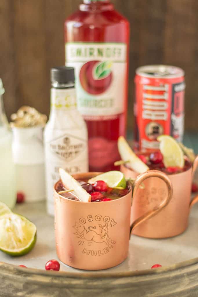 Serve this Cranberry Apple Moscow Mule at your parties this season and you'll always have a full house. Cranberry Apple vodka is crafted with black walnut bitters, ginger beer and lime giving a delicious nutty Fall twist to a classic! | Strawberry Blondie Kitchen