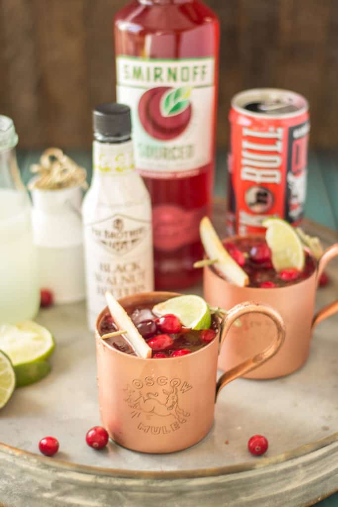 Serve this Cranberry Apple Moscow Mule at your parties this season and you'll always have a full house. Cranberry Apple vodka is crafted with black walnut bitters, ginger beer and lime giving a delicious nutty Fall twist to a classic! | Strawberry Blondie Kitchen