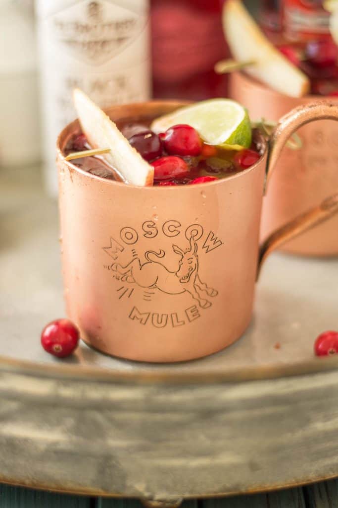 Serve this Cranberry Apple Moscow Mule at your parties this season and you'll always have a full house. Cranberry Apple vodka is crafted with black walnut bitters, ginger beer and lime giving a delicious nutty Fall twist to a classic! | Strawberry Blondie Kitchen