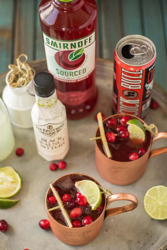 Serve this Cranberry Apple Moscow Mule at your parties this season and you'll always have a full house. Cranberry Apple vodka is crafted with black walnut bitters, ginger beer and lime giving a delicious nutty Fall twist to a classic! | Strawberry Blondie Kitchen