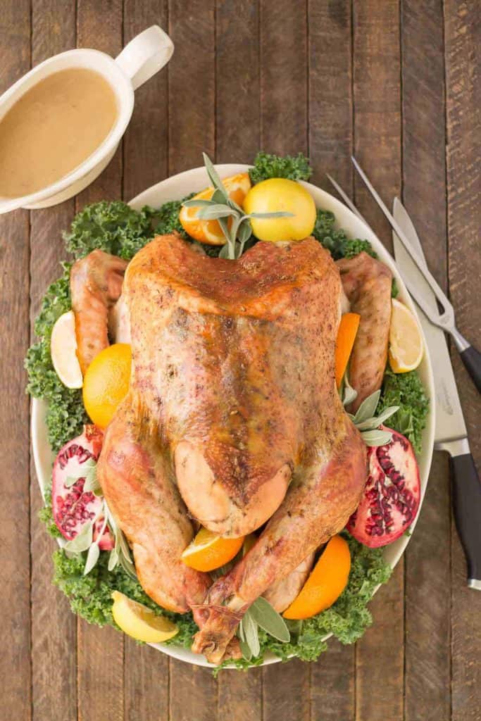 Golden roasted turkey with meat thermometer on table Stock Photo