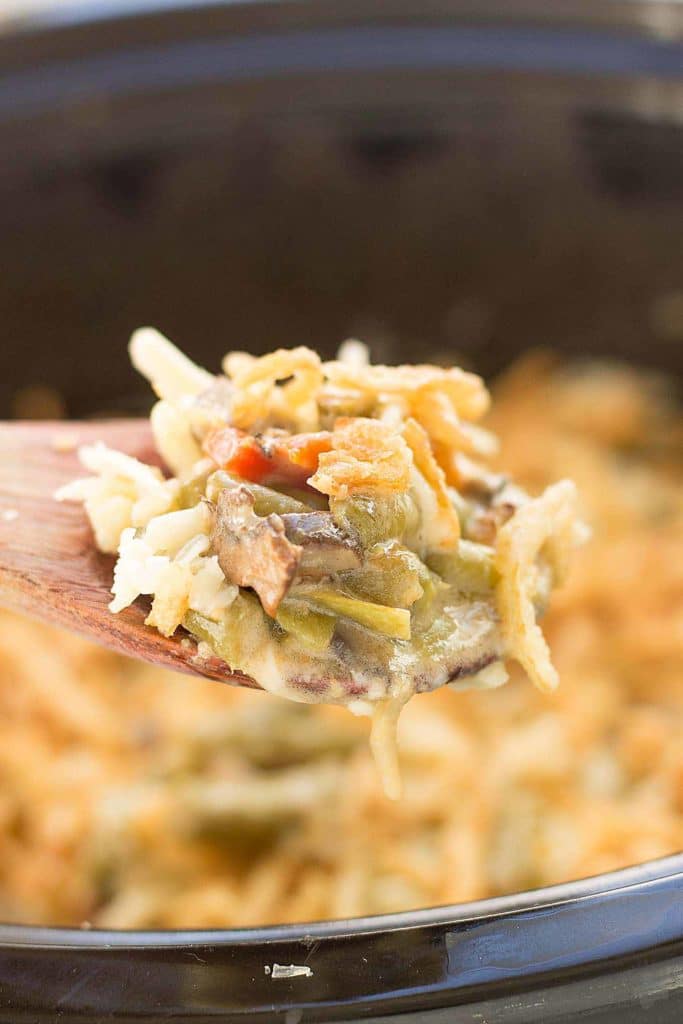 Sharp white cheddar cheese elevates this Slow Cooker White Cheddar Green Bean Casserole to make it the star side dish of your holiday table! | Strawberry Blondie Kitchen