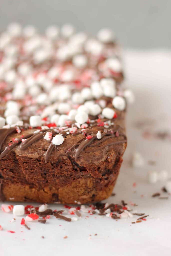 These Peppermint Hot Chocolate Brookies feature a layer of chocolate chip cookies, peppermint sandwich cookies, a layer of brownies and then topped with dark chocolate, crushed peppermint and mini marshmallows. | Strawberry Blondie Kitchen