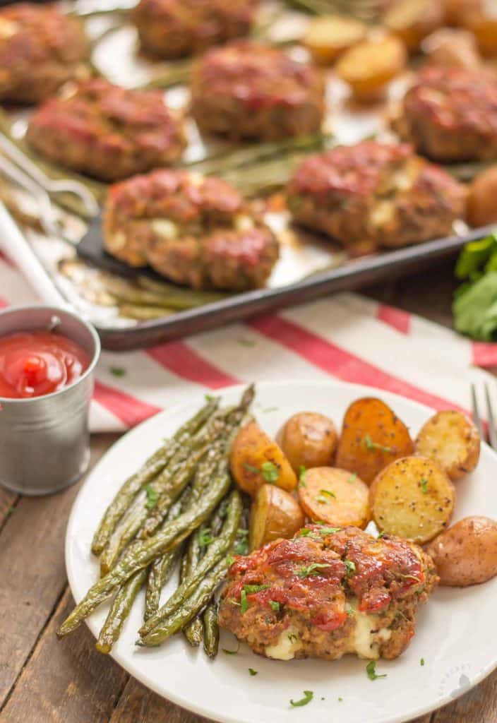 Sheet Pan Mini Meatloaves with Potatoes and Green Beans on a white plate. Serve with an extra side of ketchup