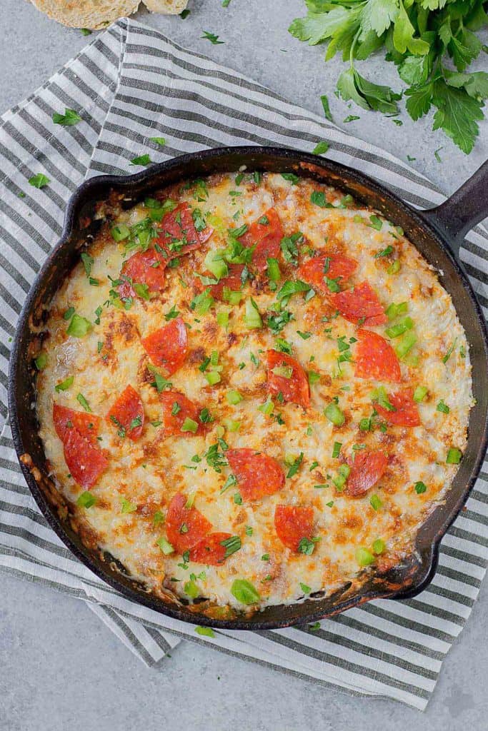 Supreme Pizza Dip is an ooey, gooey, cheesy dip sure to please everyone!  Filled with your favorite pizza toppings, it's sure to be a crowd pleaser! | Strawberry Blondie Kitchen