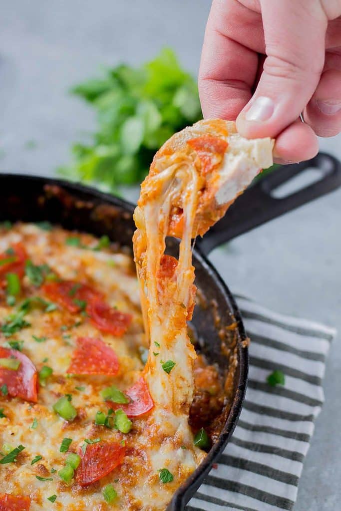 Supreme Pizza Dip is an ooey, gooey, cheesy dip sure to please everyone!  Filled with your favorite pizza toppings, it's sure to be a crowd pleaser! | Strawberry Blondie Kitchen