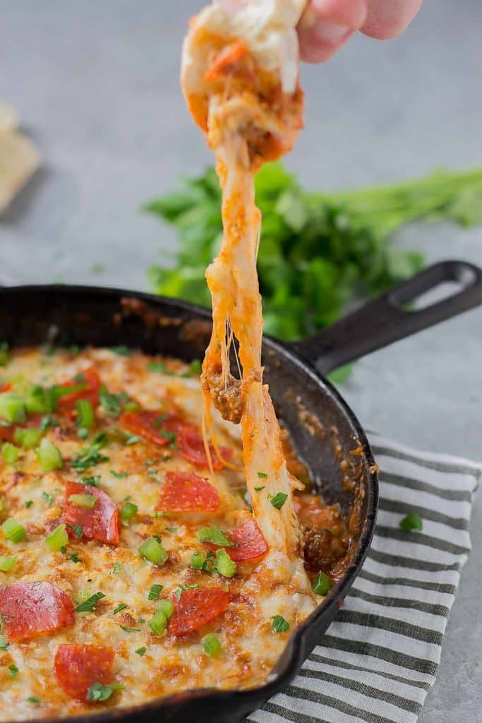 Supreme Pizza Dip is an ooey, gooey, cheesy dip sure to please everyone!  Filled with your favorite pizza toppings, it's sure to be a crowd pleaser! | Strawberry Blondie Kitchen