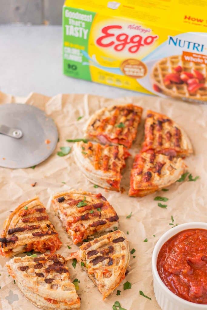 Get the kids into the kitchen and mix up your Eggo waffles. Start with an ingredient bar full of their favorite pizza toppings to create these fun Pizza Wafflewiches. | Strawberry Blondie Kitchen