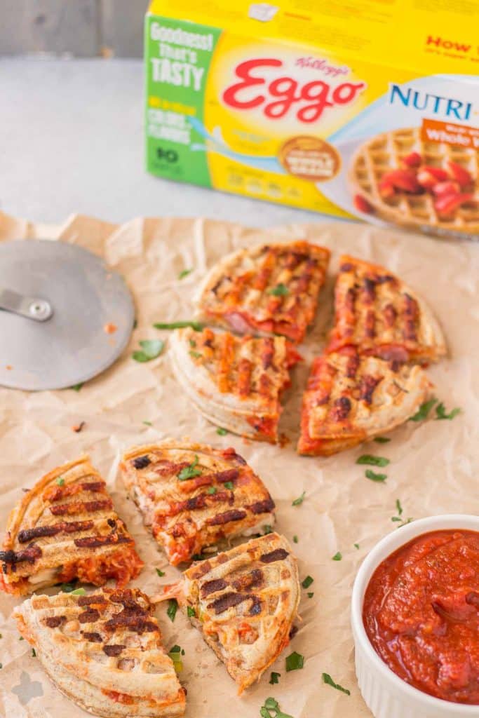 Get the kids into the kitchen and mix up your Eggo waffles. Start with an ingredient bar full of their favorite pizza toppings to create these fun Pizza Wafflewiches. | Strawberry Blondie Kitchen