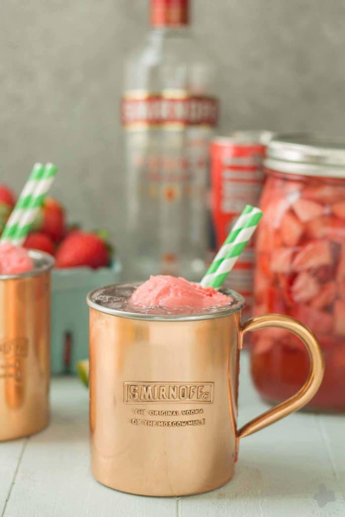 No need to wait for summer to enjoy this delicious and refreshing Strawberry Moscow Mule Float. Made using homemade strawberry vodka and strawberry sorbet, you're sure to love this twist on a classic! | Strawberry Blondie Kitchen