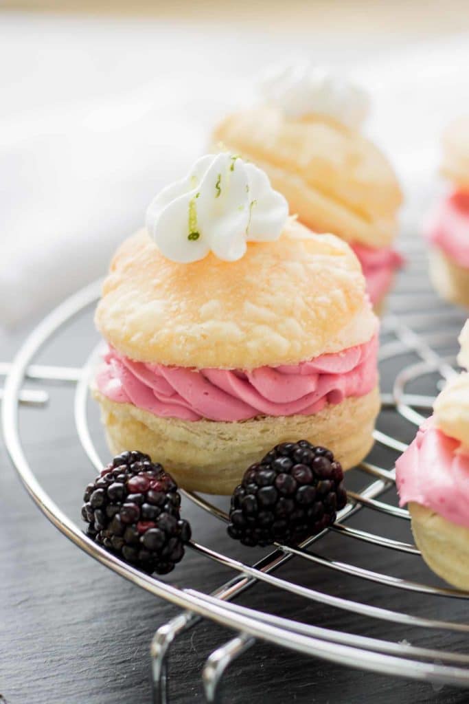 These elegant but simple, Blackberry Lime Buttercream Puffs are sweet, creamy and light. They're filled with a delicious homemade lime curd and fresh blackberry compote. | Strawberry Blondie Kitchen