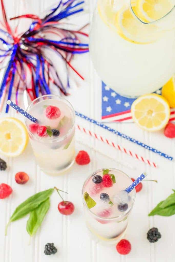 Refreshing and delicious, this Spiked Triple Berry Basil Lemonade is a perfect balance of sweet and tart. Smirnoff® Red, White and Berry vodka mixed with tart lemonade and fresh, sweet berries is the ultimate summertime cocktail! | Strawberry Blondie Kitchen