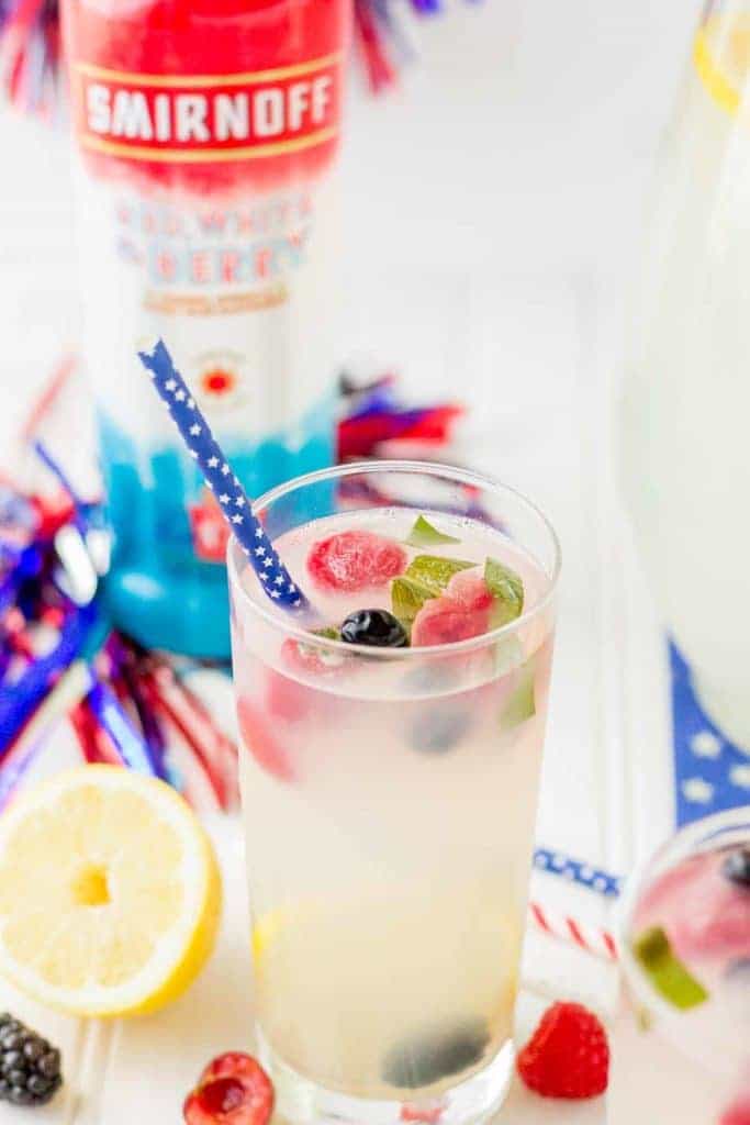 Refreshing and delicious, this Spiked Triple Berry Basil Lemonade is a perfect balance of sweet and tart. Smirnoff® Red, White and Berry vodka mixed with tart lemonade and fresh, sweet berries is the ultimate summertime cocktail! | Strawberry Blondie Kitchen