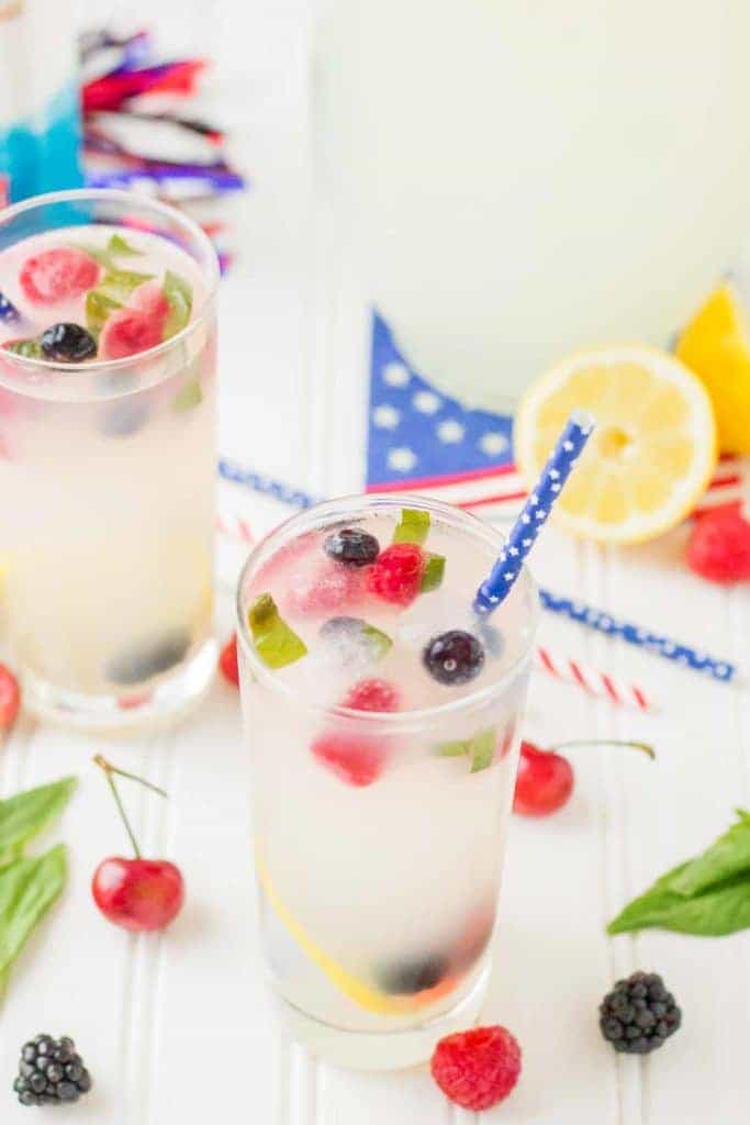 Refreshing and delicious, this Spiked Triple Berry Basil Lemonade is a perfect balance of sweet and tart. Smirnoff® Red, White and Berry vodka mixed with tart lemonade and fresh, sweet berries is the ultimate summertime cocktail! | Strawberry Blondie Kitchen