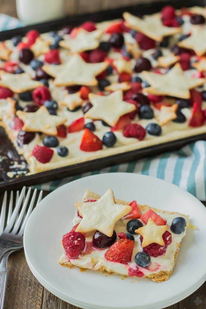 What is more Patriotic than a Star Spangled Berry Sheet Pan Pie?  It's an all American pie loaded with berries, citrus flavors and studded with pie stars.  A delicious addition to all your festive parties this year! | Strawberry Blondie Kitchen