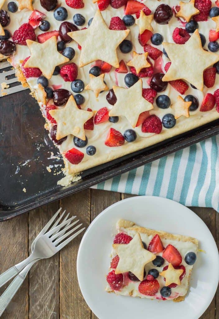 What is more Patriotic than a Star Spangled Berry Sheet Pan Pie?  It's an all American pie loaded with berries, citrus flavors and studded with pie stars.  A delicious addition to all your festive parties this year! | Strawberry Blondie Kitchen