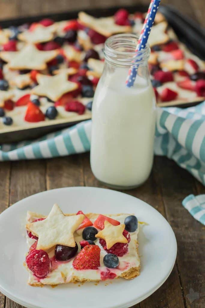 What is more Patriotic than a Star Spangled Berry Sheet Pan Pie?  It's an all American pie loaded with berries, citrus flavors and studded with pie stars.  A delicious addition to all your festive parties this year! | Strawberry Blondie Kitchen