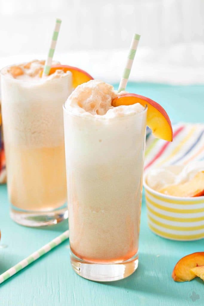 With 4 ingredients, your only 5 minutes away from a fun and delicious Peaches and Cream Soda.  Peach syrup, cream, ice cream and club soda make this Peaches and Cream Soda delightful and the perfect summer sipper! Strawberry Blondie Kitchen