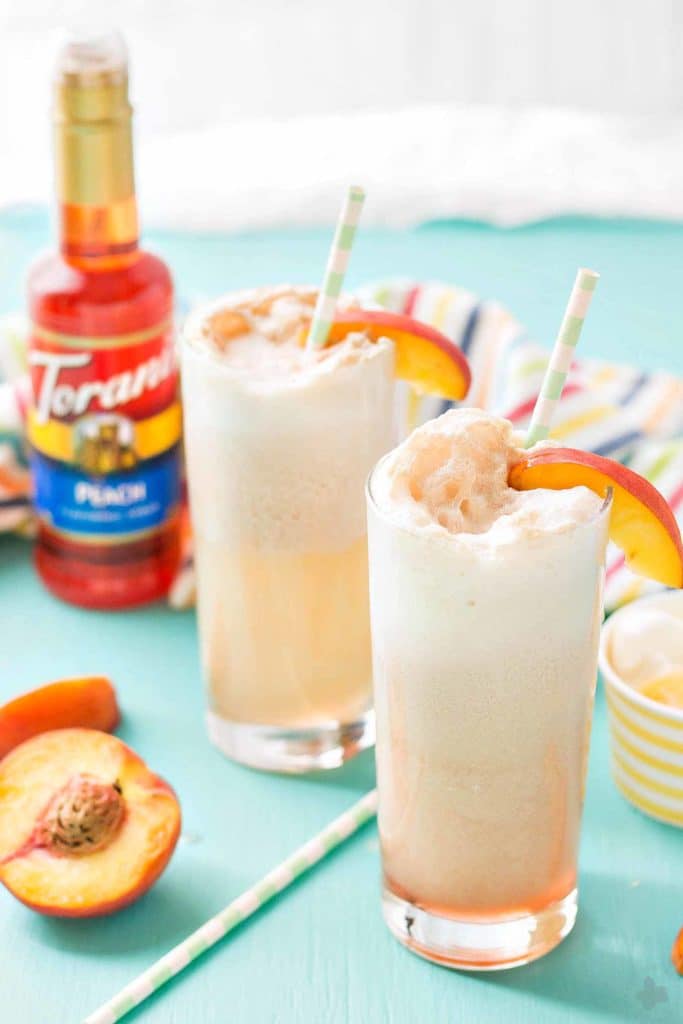 With 4 ingredients, your only 5 minutes away from a fun and delicious Peaches and Cream Soda.  Peach syrup, cream, ice cream and club soda make this Peaches and Cream Soda delightful and the perfect summer sipper! Strawberry Blondie Kitchen