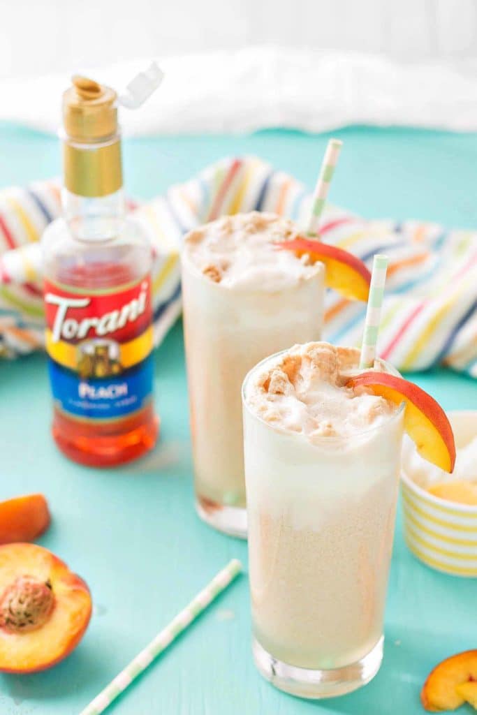 With 4 ingredients, your only 5 minutes away from a fun and delicious Peaches and Cream Soda.  Peach syrup, cream, ice cream and club soda make this Peaches and Cream Soda delightful and the perfect summer sipper! Strawberry Blondie Kitchen