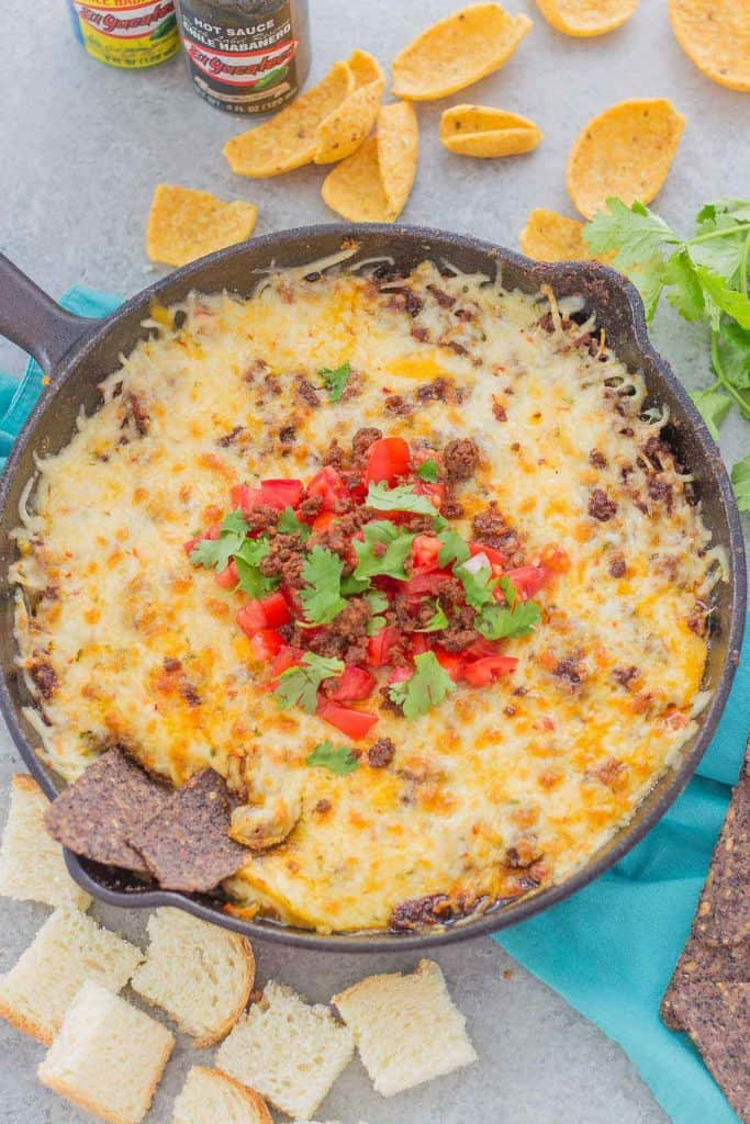 Chorizo Queso Fundido is a delicious and flavorful dip filled with cheeses, chorizo, tequila and El Yucateco® hot sauce.  It's the perfect appetizer for game day and everything in between! | Strawberry Blondie Kitchen