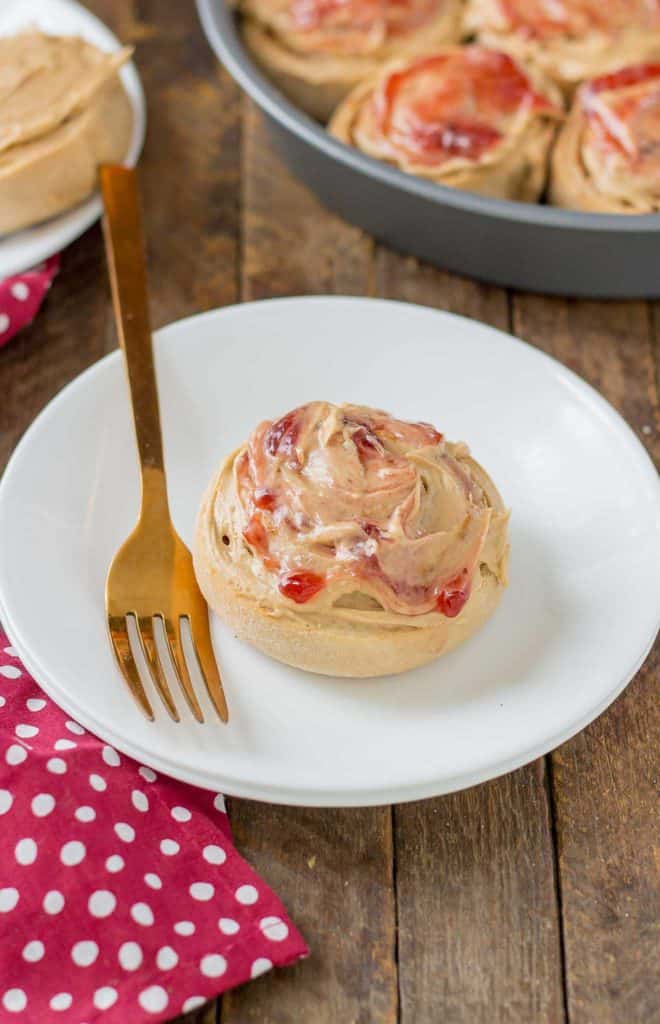 These Peanut Butter and Jelly Breakfast rolls are breakfast bliss.  Peanut butter flavored rolls, stuffed with jelly and topped with a peanut butter frosting are the best breakfast rolls yet! | Strawberry Blondie Kitchen