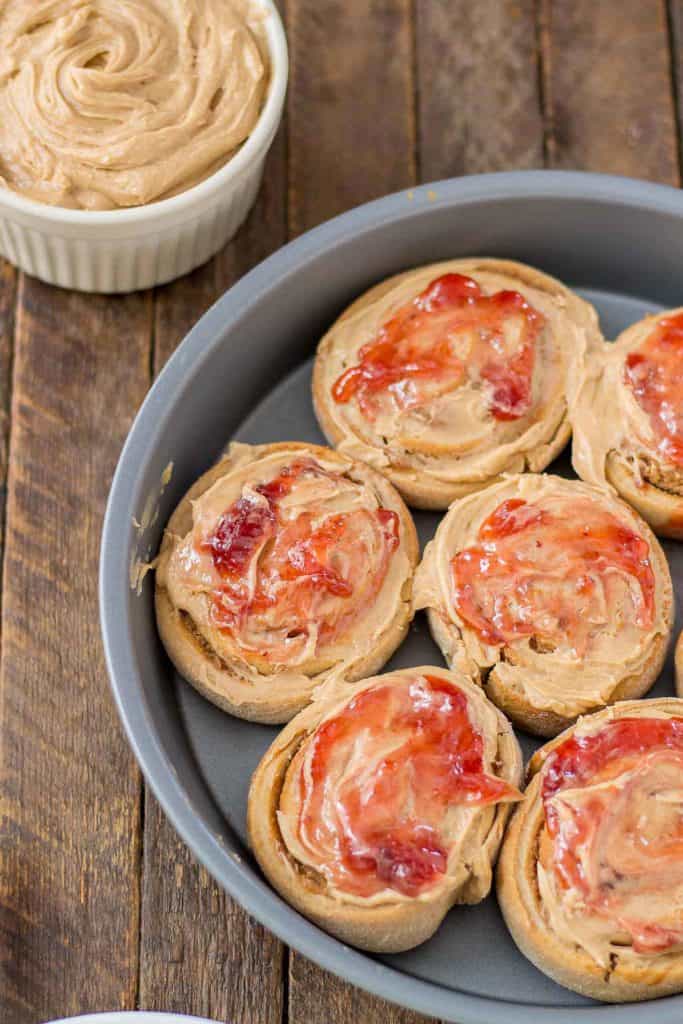 These Peanut Butter and Jelly Breakfast rolls are breakfast bliss.  Peanut butter flavored rolls, stuffed with jelly and topped with a peanut butter frosting are the best breakfast rolls yet! | Strawberry Blondie Kitchen