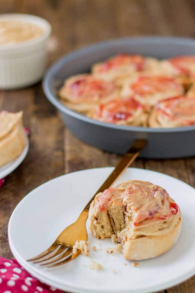 These Peanut Butter and Jelly Breakfast rolls are breakfast bliss.  Peanut butter flavored rolls, stuffed with jelly and topped with a peanut butter frosting are the best breakfast rolls yet! | Strawberry Blondie Kitchen