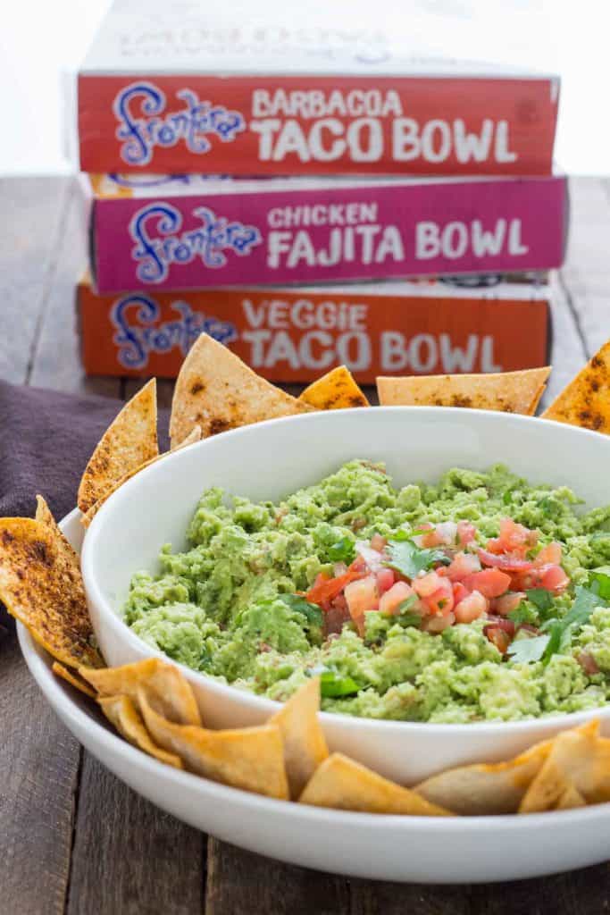 All the flavors you love of guacamole with an added boost of protein and fiber make this Edamame Guacamole super flavorful and a good for you dip. Paired with homemade smoky tortilla chips and you've got one delicious snack. | Strawberry Blondie Kitchen