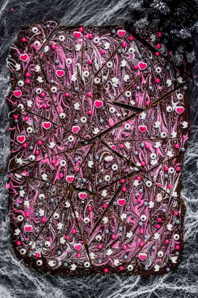 Super pretty and sparkly Halloween colors such as pink, silver and black make this Pink-O-Ween Candy Bark fun and creative.  Share it with the pink lover in your life! ? | Strawberry Blondie Kitchen