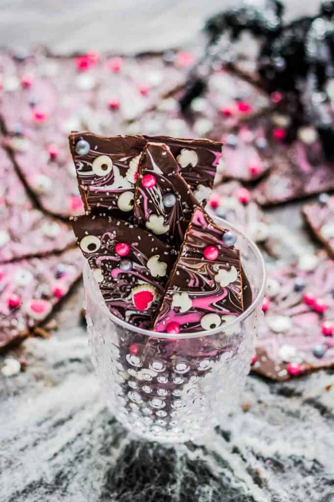 Super pretty and sparkly Halloween colors such as pink, silver and black make this Pink-O-Ween Candy Bark fun and creative.  Share it with the pink lover in your life! ? | Strawberry Blondie Kitchen
