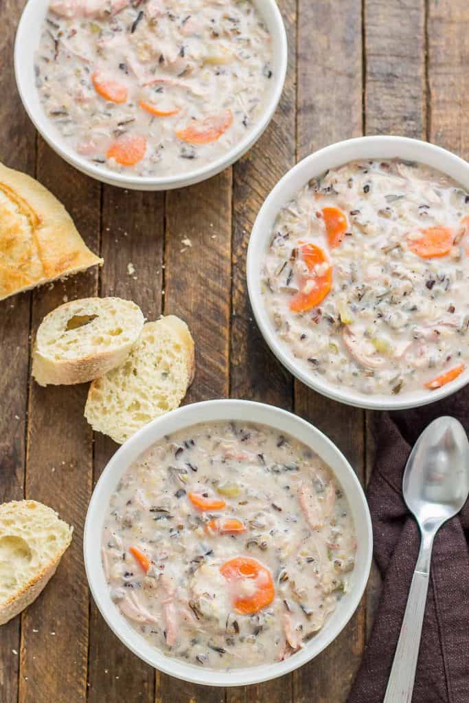 Creamy, delicious and pure comfort food, this healthy Crockpot Chicken and Wild Rice Soup comes together quickly thanks to your slow cooker.  Serve it tonight with some bread for dunking! | Strawberry Blondie Kitchen