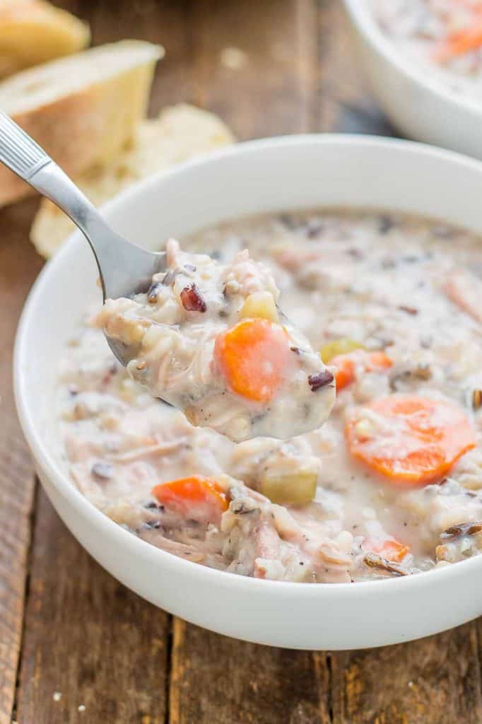 Creamy, delicious and pure comfort food, this healthy Crockpot Chicken and Wild Rice Soup comes together quickly thanks to your slow cooker.  Serve it tonight with some bread for dunking! | Strawberry Blondie Kitchen