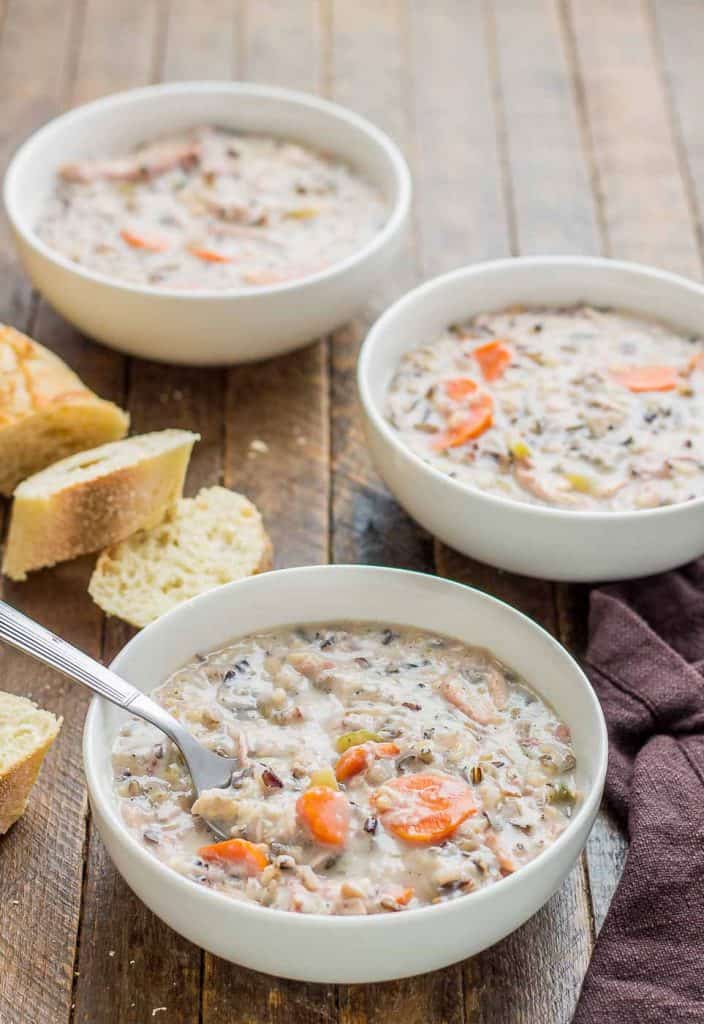 Creamy, delicious and pure comfort food, this healthy Crockpot Chicken and Wild Rice Soup comes together quickly thanks to your slow cooker.  Serve it tonight with some bread for dunking! | Strawberry Blondie Kitchen