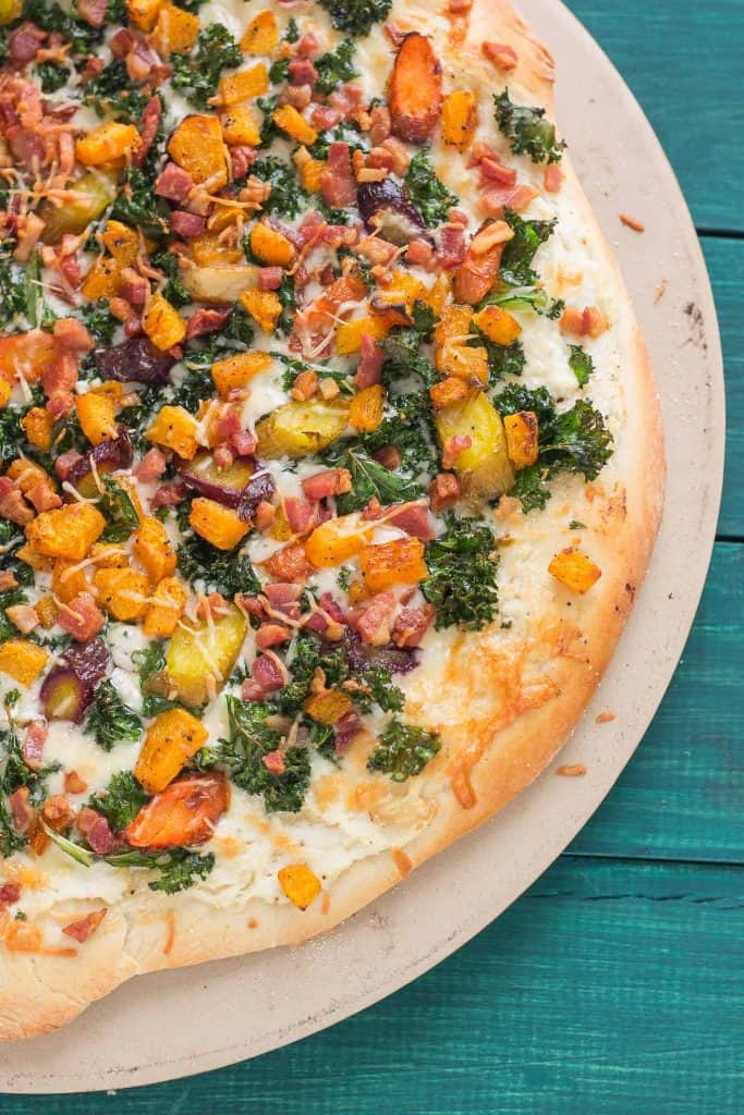 Autumn Harvest Pizza features roasted vegetables; butternut squash, carrots and garlic, buttery cheese, kale and pancetta to give you the best of fall in a fabulously delicious pizza! | Strawberry Blondie Kitchen