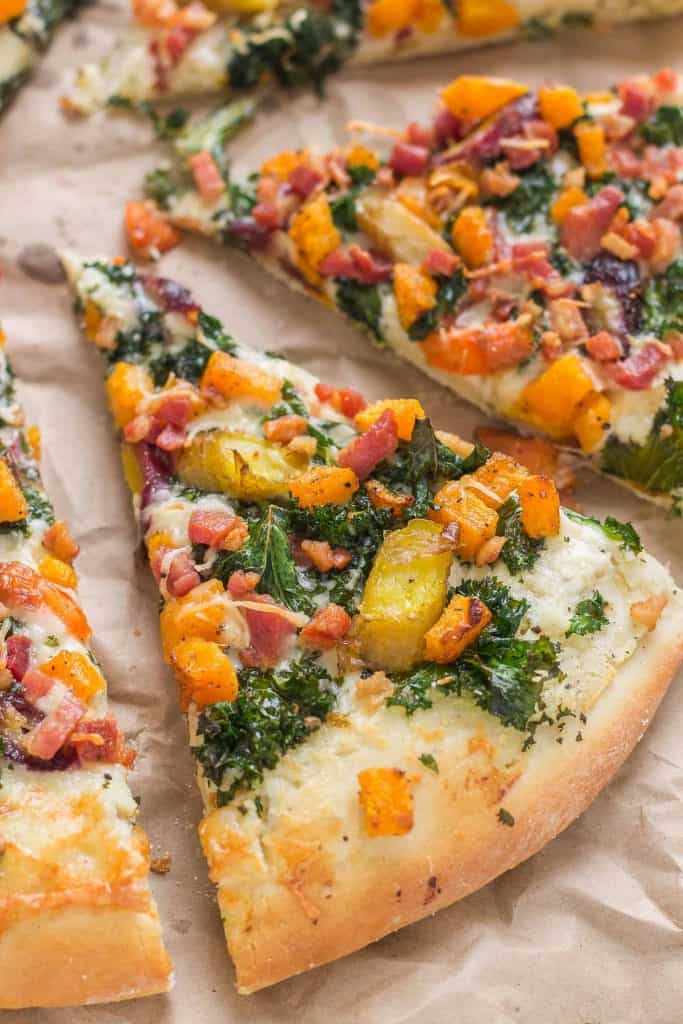 Autumn Harvest Pizza features roasted vegetables; butternut squash, carrots and garlic, buttery cheese, kale and pancetta to give you the best of fall in a fabulously delicious pizza! | Strawberry Blondie Kitchen