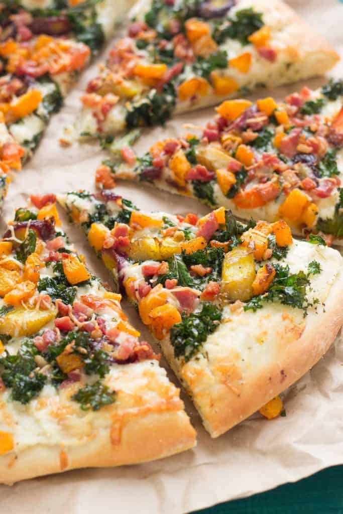 Autumn Harvest Pizza features roasted vegetables; butternut squash, carrots and garlic, buttery cheese, kale and pancetta to give you the best of fall in a fabulously delicious pizza! | Strawberry Blondie Kitchen