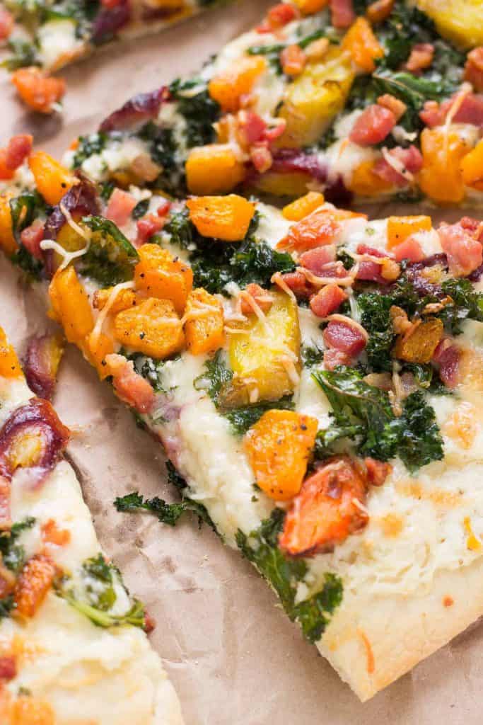 Autumn Harvest Pizza features roasted vegetables; butternut squash, carrots and garlic, buttery cheese, kale and pancetta to give you the best of fall in a fabulously delicious pizza! | Strawberry Blondie Kitchen