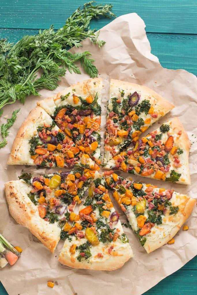 Autumn Harvest Pizza features roasted vegetables; butternut squash, carrots and garlic, buttery cheese, kale and pancetta to give you the best of fall in a fabulously delicious pizza! | Strawberry Blondie Kitchen