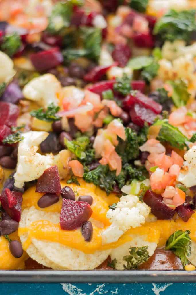 Fall Bounty Sheet Pan Nachos have butternut squash nacho cheese sauce, black beans, kale, roasted cauliflower and beets to give you the ultimate in snacking with all of Fall's delicious produce! | Strawberry Blondie Kitchen