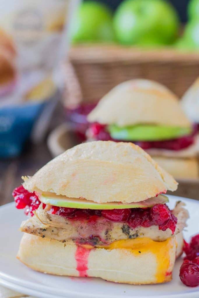 Crispy rolls, smoky turkey and cheese, with tart apples and sweet cranberry sauce come together harmoniously to create these Turkey Cheddar Cran Apple Sliders which are perfect for Thanksgiving leftovers. | Strawberry Blondie Kitchen