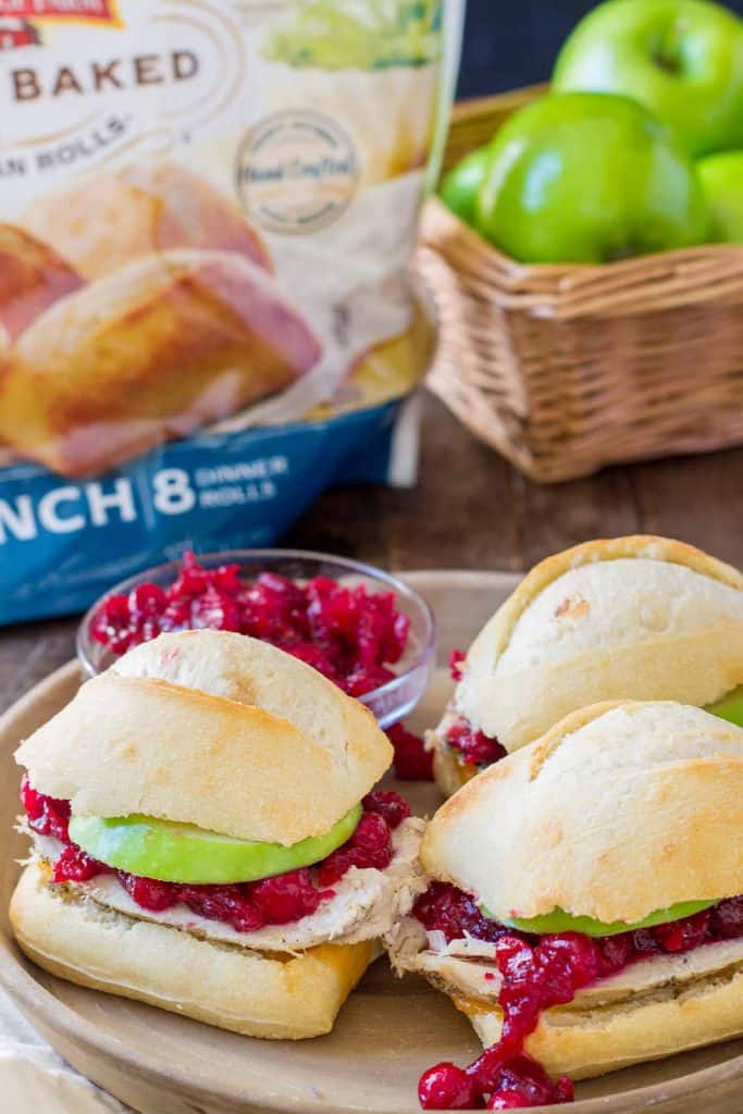 Crispy rolls, smoky turkey and cheese, with tart apples and sweet cranberry sauce come together harmoniously to create these Turkey Cheddar Cran Apple Sliders which are perfect for Thanksgiving leftovers. | Strawberry Blondie Kitchen