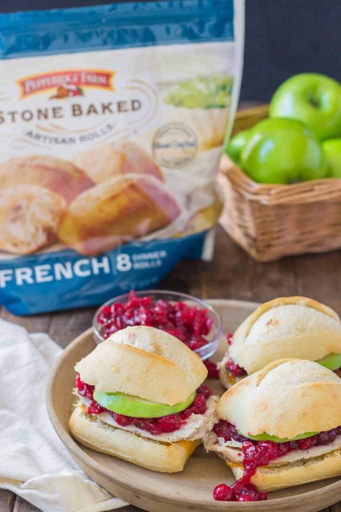 Crispy rolls, smoky turkey and cheese, with tart apples and sweet cranberry sauce come together harmoniously to create these Turkey Cheddar Cran Apple Sliders which are perfect for Thanksgiving leftovers. | Strawberry Blondie Kitchen